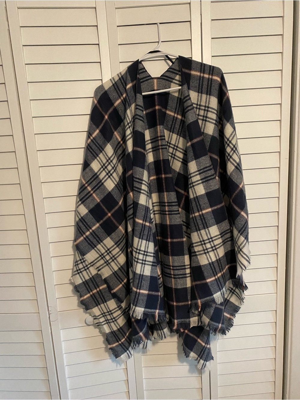 White, navy blue, and red poncho